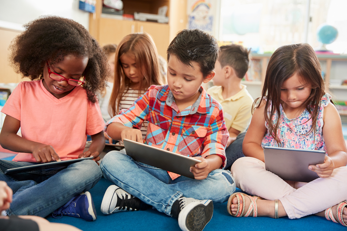 young students using tablets in the classroom